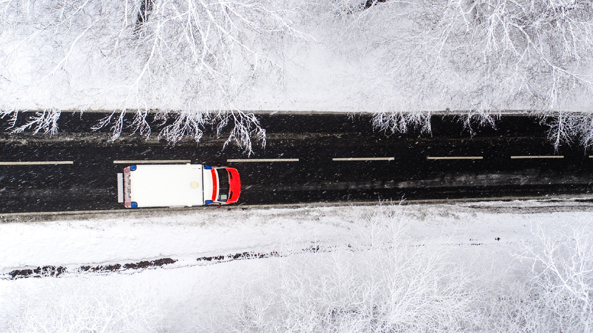 Aerial shot of lorry driving through snow