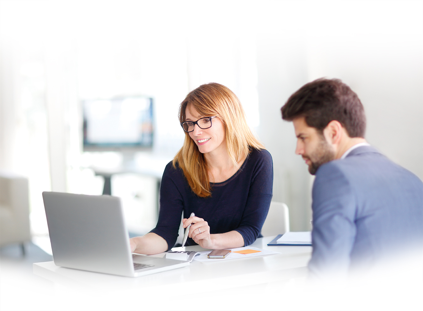 Financial advisor with client in front of laptop